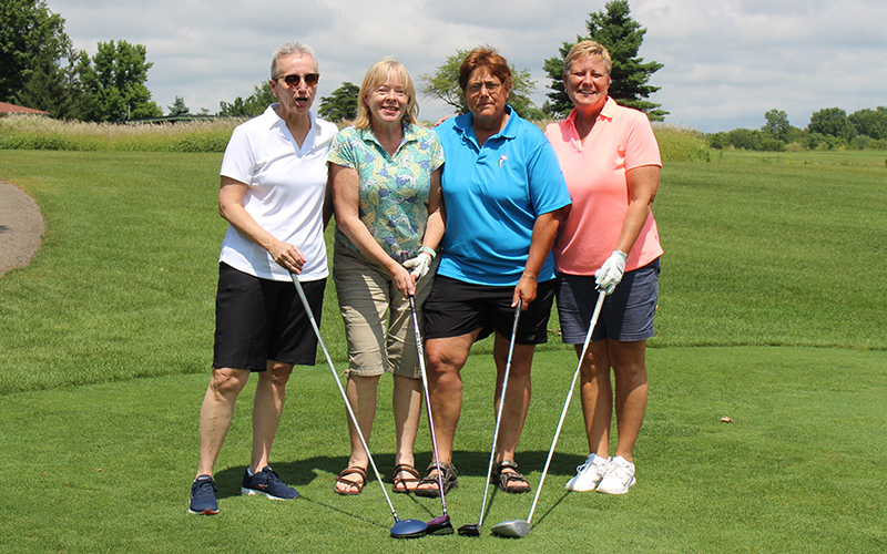 Group of four golfers on a golf course